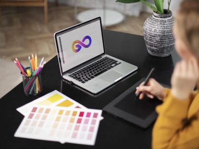 female-logo-designer-working-her-tablet-connected-laptop